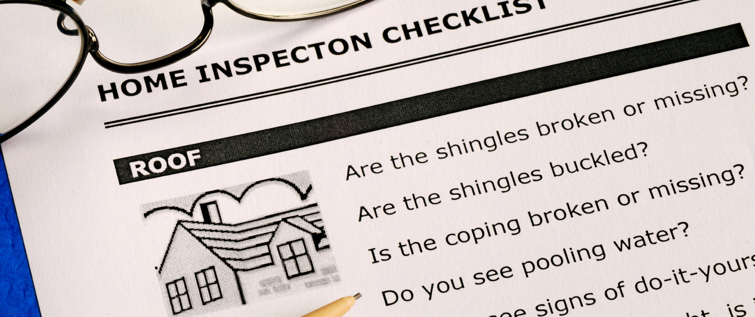Home inspection checklist with reading glasses and a pen